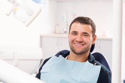 man smiling sitting in the dental chair