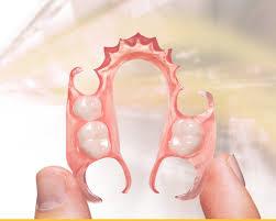 hand holding a flexible oral partial denture in Tampa