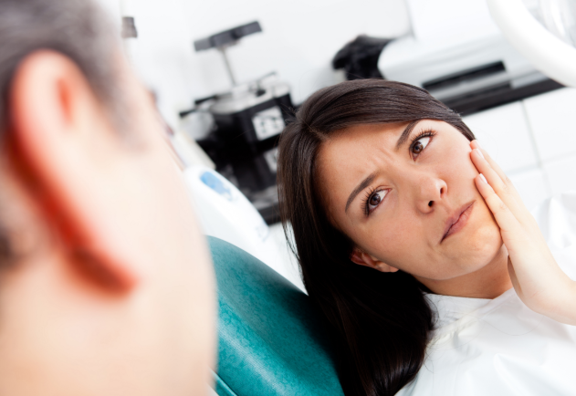 woman concerned sitting in a dental chair