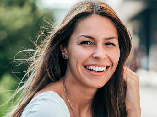 Woman with dental crowns smiling in Tampa, FL