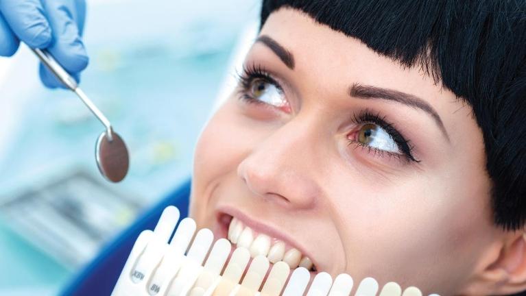 woman in dental chair using tooth color shade