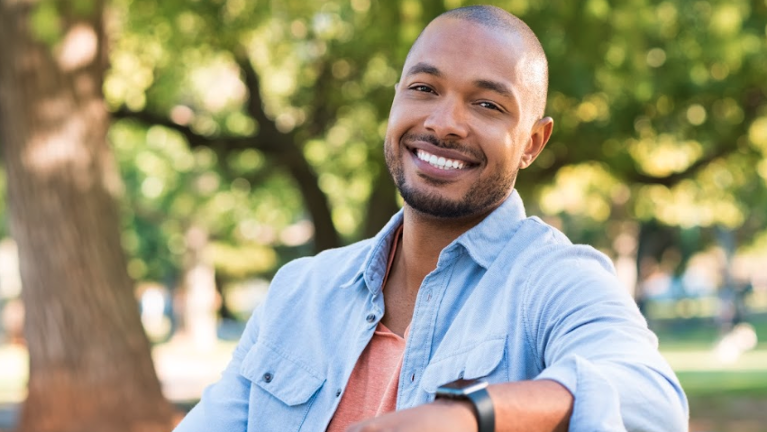 Man with dental crowns smiling in North Tampa, FL