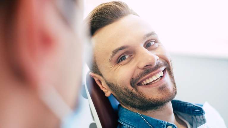 Male dental patient sits in a dental chair in North Tampa