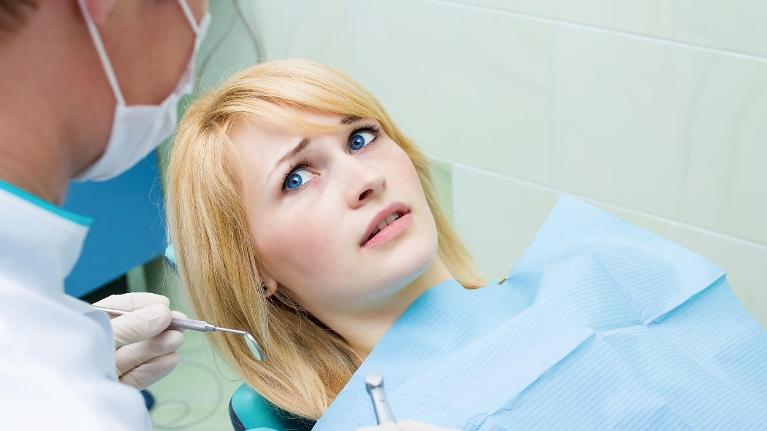 woman frightened in dental chair