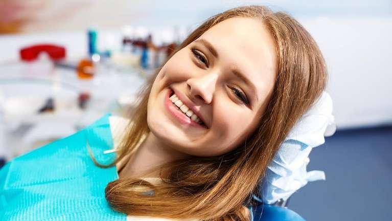 Woman smiling in treatment chair at dentist for sedation Tampa, FL