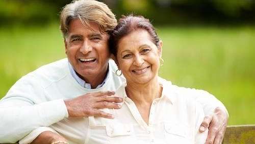 Couple with dentures smiling at Lake Conservation Park in Lutz, FL